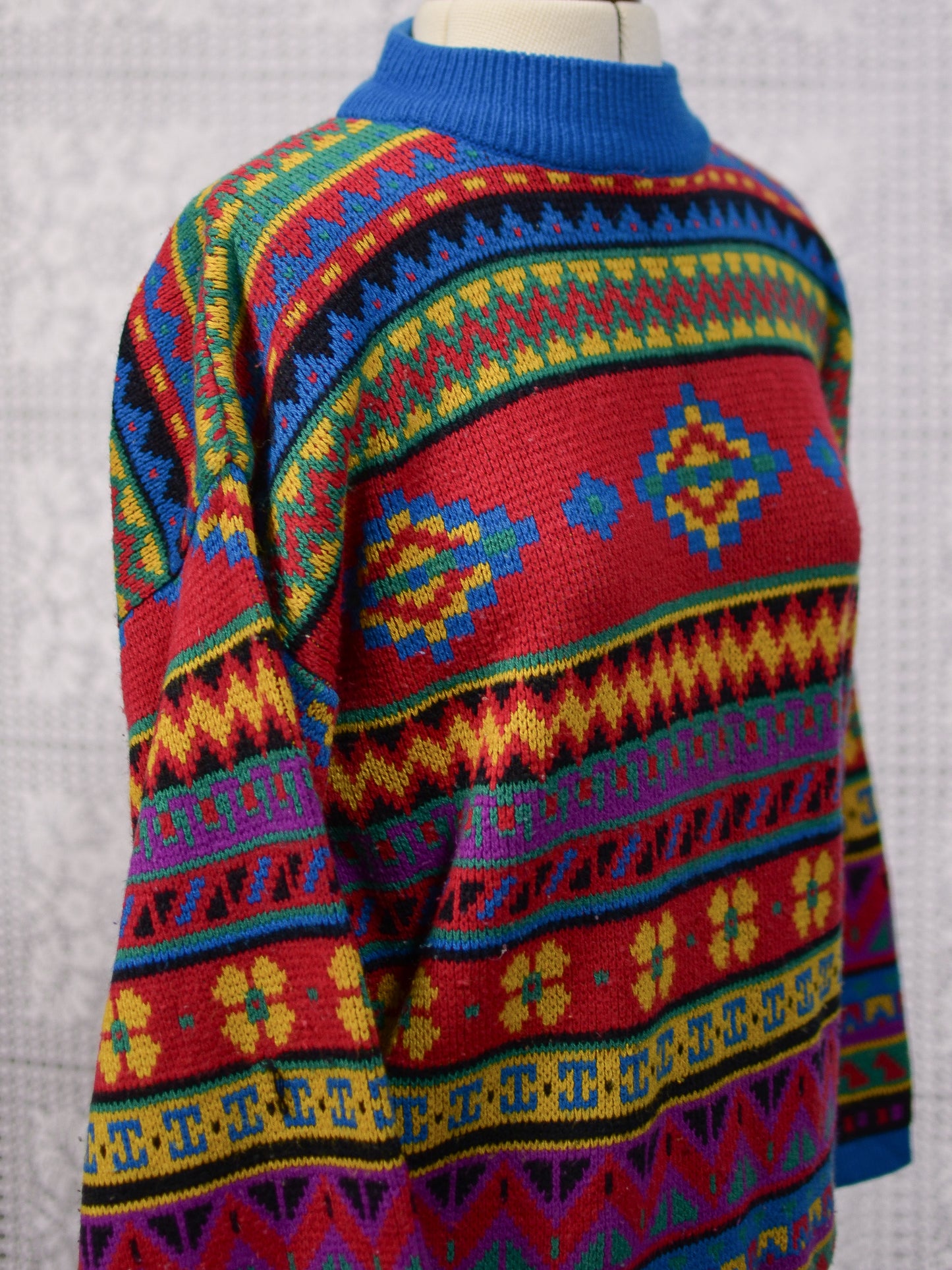 1990s blue, red and yellow colourful geometric floral patterned jumper