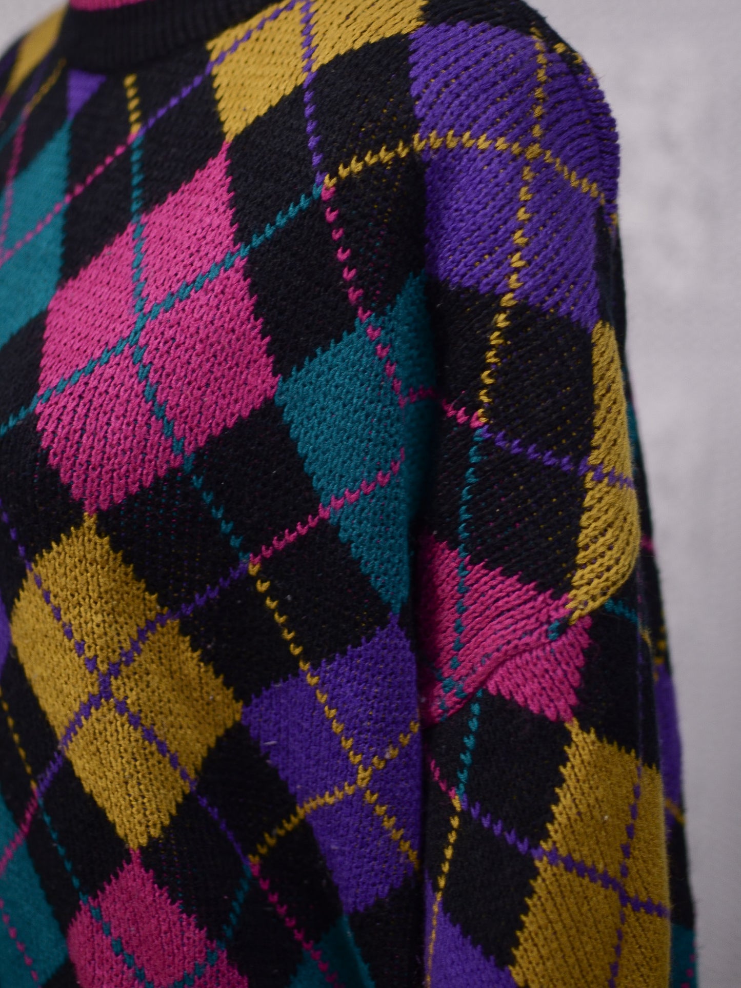 1980s black, pink, yellow, purple and turquoise green argyle pattern jumper