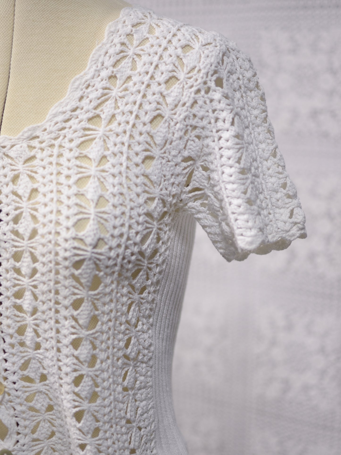 1990s New Look white crocheted short sleeve cardigan with shell buttons