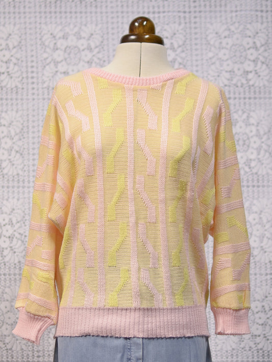 1980s pink and yellow geometric pattern batwing jumper