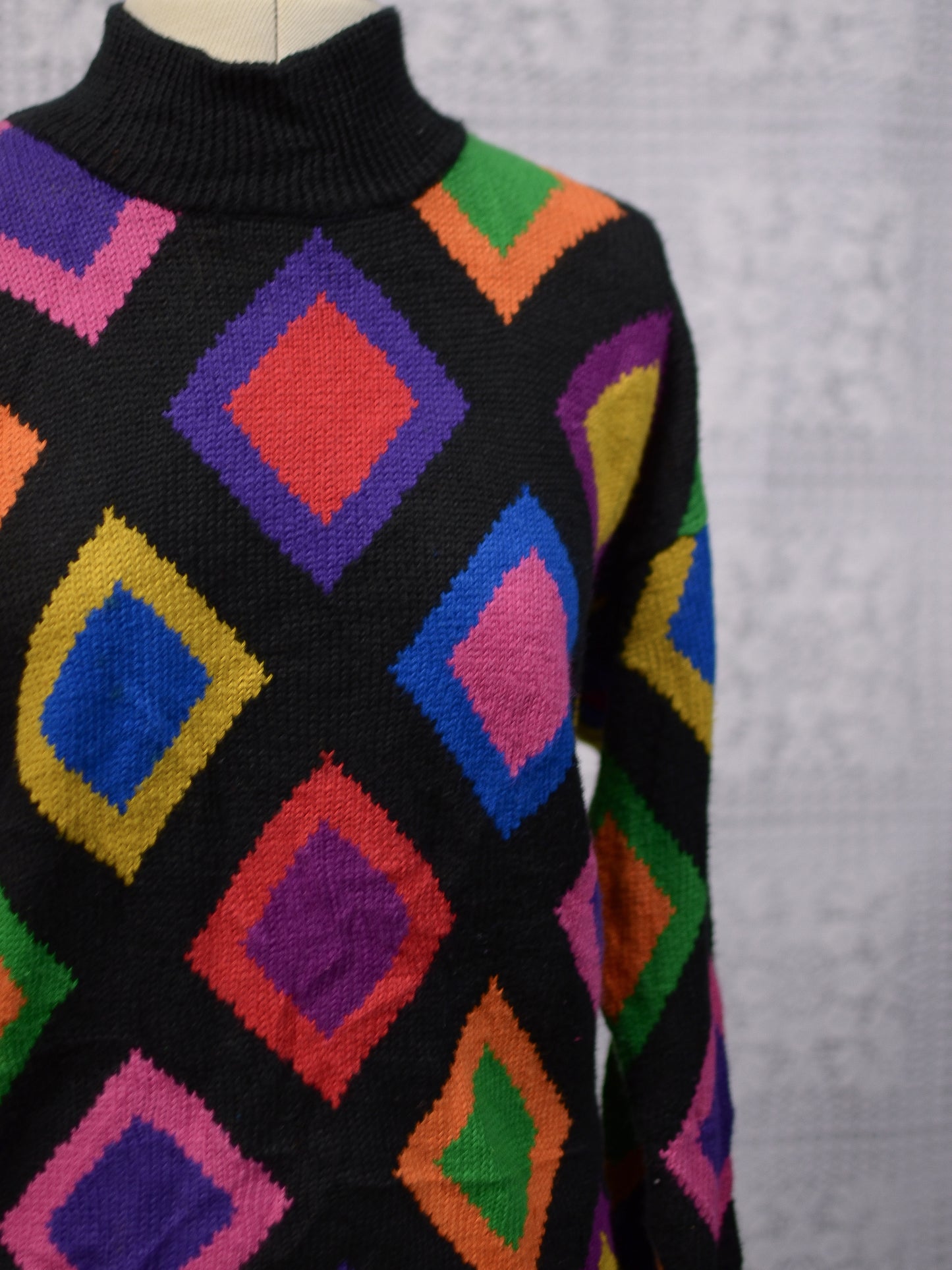 1990s black and brightly coloured diamond pattern high neck long jumper