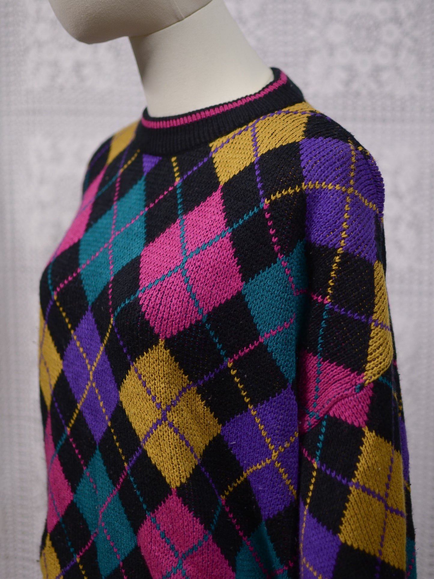 1980s black, pink, yellow, purple and turquoise green argyle pattern jumper