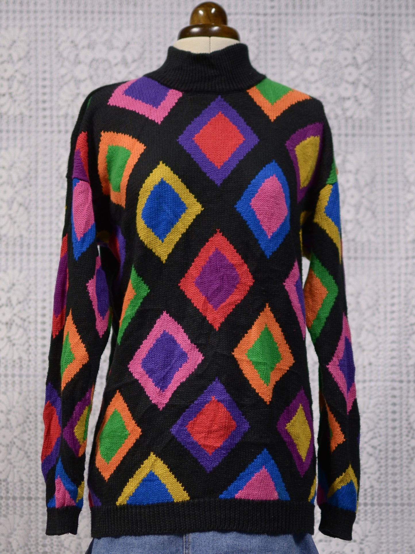 1990s black and brightly coloured diamond pattern high neck long jumper