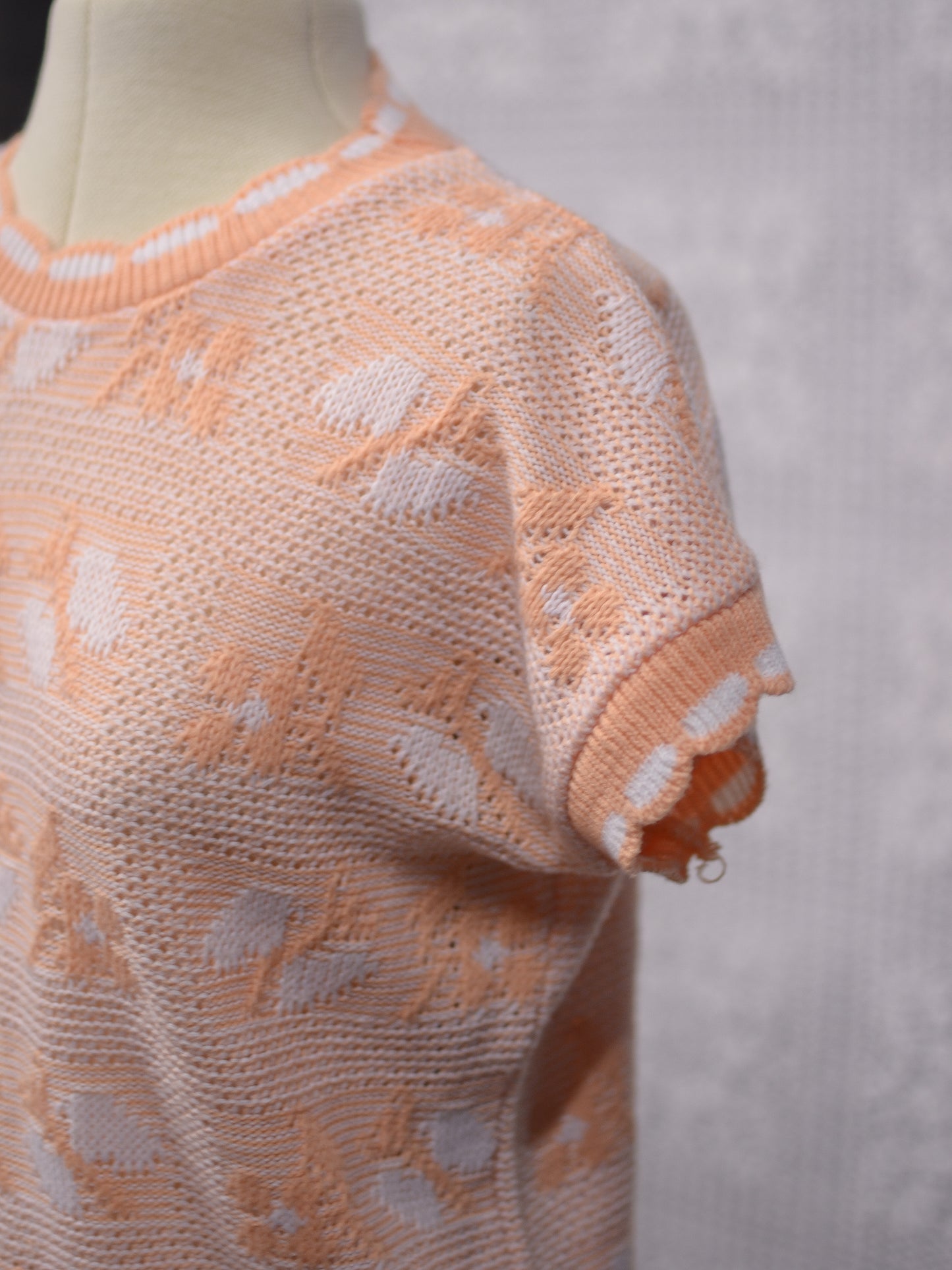 1980s peachy orange and white sleeveless jumper sweater vest