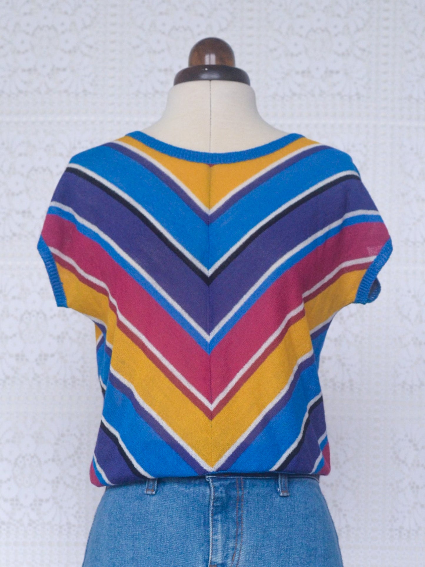 1980s style blue, purple, pink and yellow chevron sleeveless jumper
