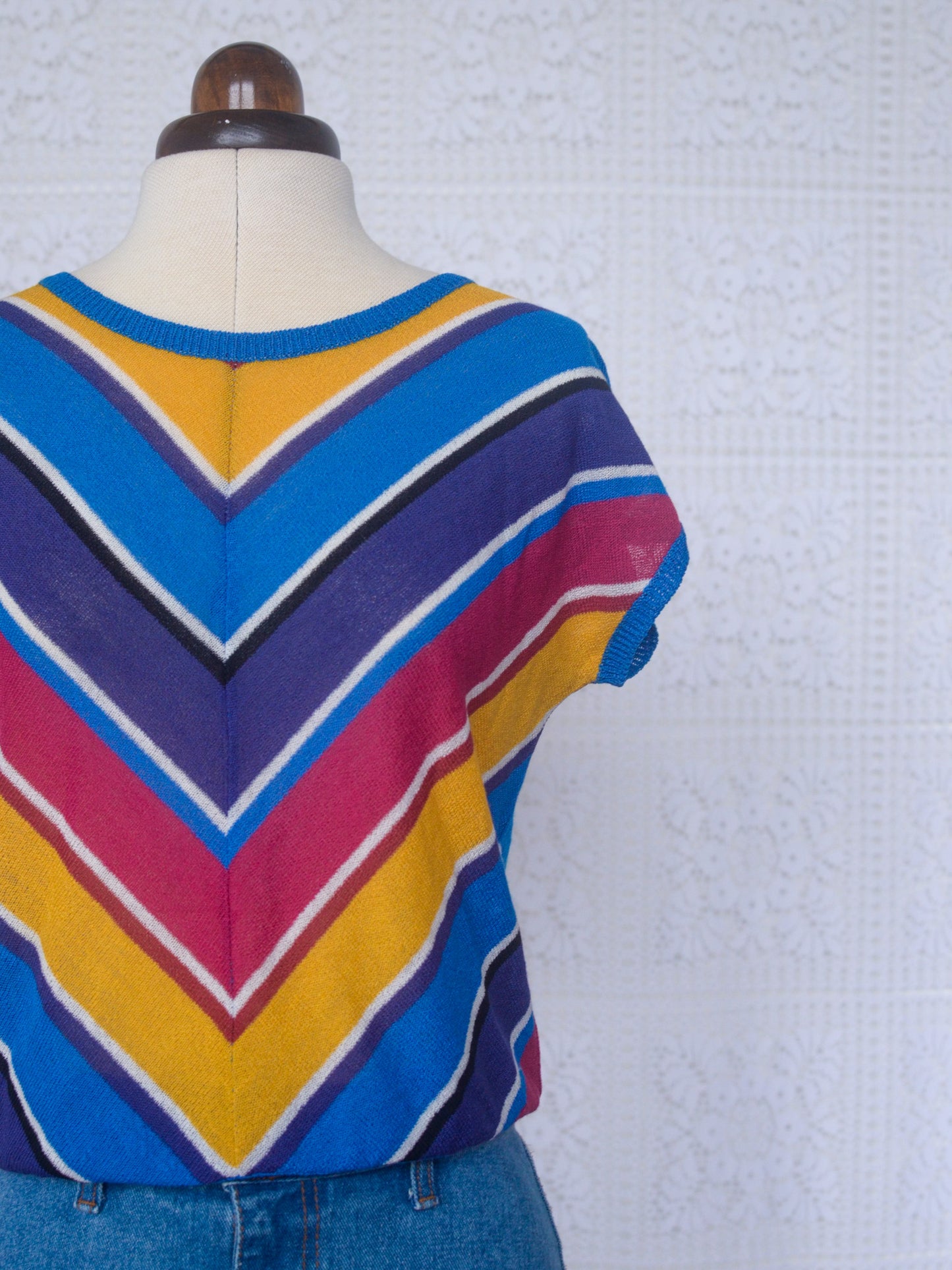 1980s style blue, purple, pink and yellow chevron sleeveless jumper